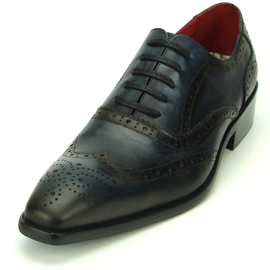 The FI-8710 Black Wing Tip Encore by Fiesso is a fashionable shoe that showcases intricate stitching and perforation details on its dark leather brogue, featuring a black heel and a striking red interior lining.