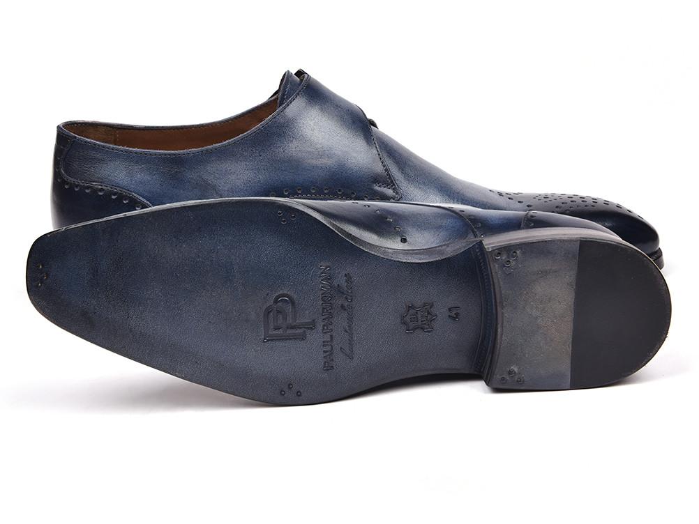 The Paul Parkman Wingtip Single Monkstraps Navy - 98F54-NVY are a pair of elegant navy leather dress shoes with brogue detailing and a monkstrap buckle, displayed on a white background. These handmade shoes from Paul Parkman are perfect for adding a touch of sophistication to any ensemble.