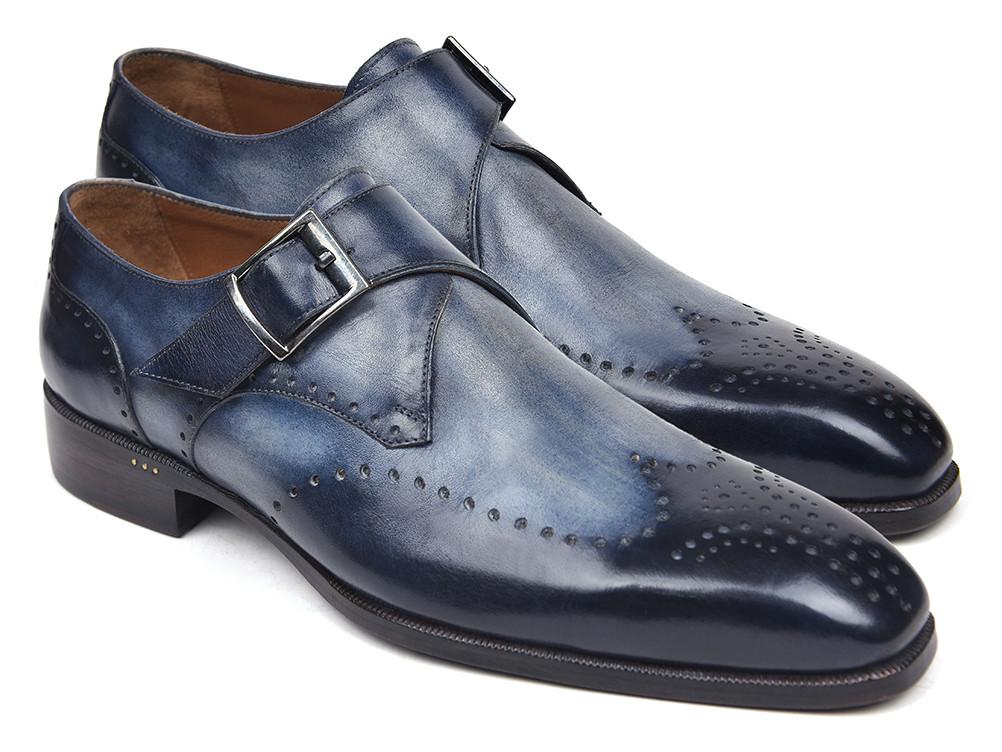 The Paul Parkman Wingtip Single Monkstraps Navy - 98F54-NVY are a pair of elegant navy leather dress shoes with brogue detailing and a monkstrap buckle, displayed on a white background. These handmade shoes from Paul Parkman are perfect for adding a touch of sophistication to any ensemble.