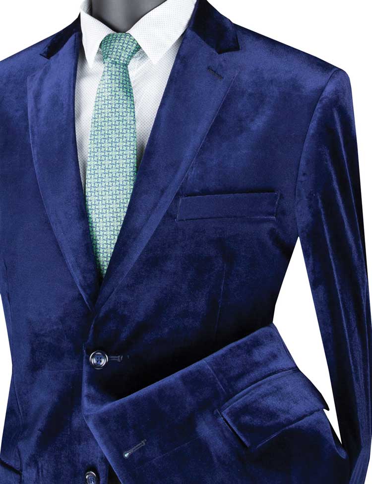 Displayed elegantly on a mannequin is the stylish Vinci Velvet Regular Fit Fashion Jacket (Sapphire) B-27 by Vinci Suits, paired with a green tie and crisp white shirt.