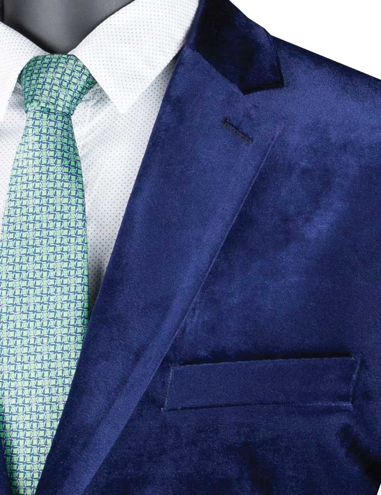 Displayed elegantly on a mannequin is the stylish Vinci Velvet Regular Fit Fashion Jacket (Sapphire) B-27 by Vinci Suits, paired with a green tie and crisp white shirt.