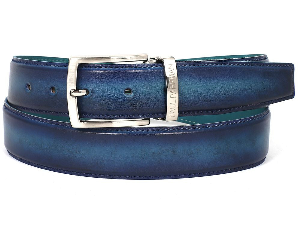 The Paul Parkman Leather Belt Dual Tone Blue & Turquoise (B01-BLU-TRQ) is a hand-painted accessory crafted from Italian calfskin leather. It features a distinctive blue hue with a silver buckle and embossed branding.