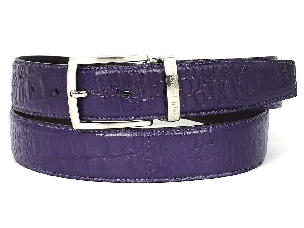 The Paul Parkman Crocodile Embossed Calfskin Leather Belt in Hand-Painted Purple, featuring a silver buckle, is coiled neatly.