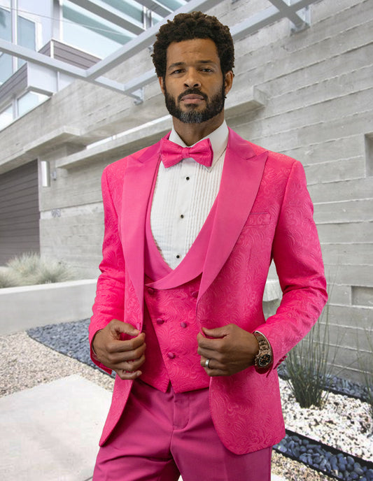 A man in the Statement Clothing BELAGIO15-HOTPINK tuxedo, featuring a tailored fit and flat front pants, stands confidently outdoors in a modern architectural setting.