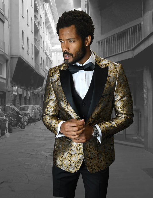 A man in a slim fit, patterned gold tuxedo from Statement Clothing's BELLAGIO-4-GOLD collection and a black bow tie stands confidently in an urban street setting.