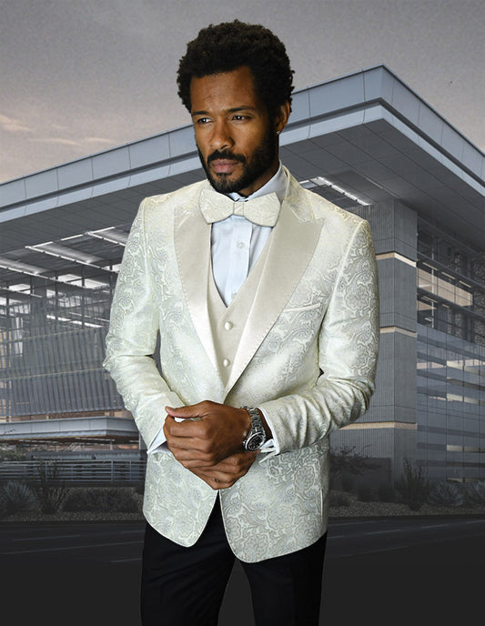 Wearing the STATEMENT CLOTHING | BELLAGIO-4-OFFWHITE suit from Statement Clothing, a man stands confidently in front of a modern glass building, his outfit complete with a bow tie.