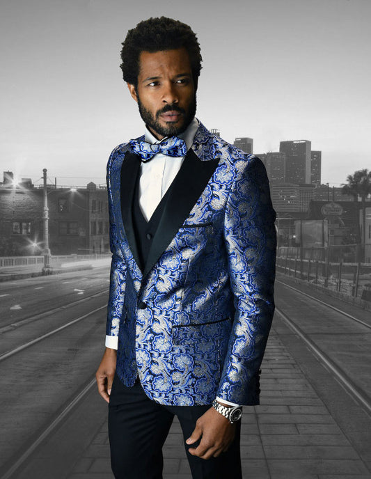 A man in a slim fit blue patterned suit and bow tie from Statement Clothing stands on a street, with the majestic skyline of Bellagio-4-Royal city in the background.