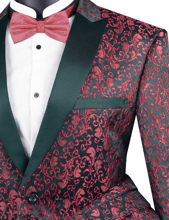 The Vinci Suits "Vinci Regular Fit Floral Pattern Jacket Peak Lapel (Red) BF-2" features a black background adorned with a red floral pattern, complemented by black lapels and paired with a red bow tie over a white shirt. Its single-breasted design adds an elegant touch to this stylish ensemble.