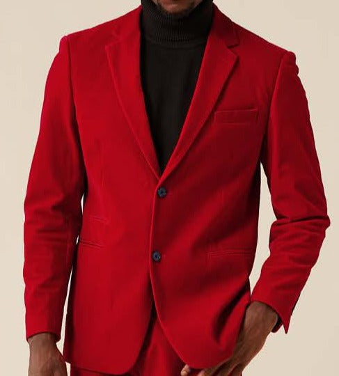 A person stands against a neutral background, wearing the Inserch Single Breasted Velvet Blazer BL521-30 in bright red. The modern fit of this blazer accentuates their silhouette, while the velvet texture subtly adds depth to their striking ensemble.