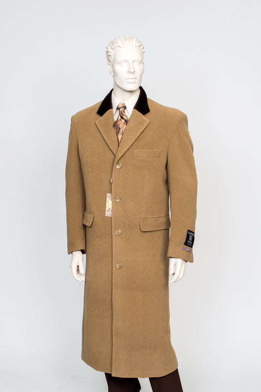 A mannequin models the XXIOTTI Cashmere/Wool Overcoat Camel 77003 by Carmel Zhao, featuring a long camel-colored design with a black collar, buttoned front, and two flap pockets. A patterned tie and part of a shirt are visible underneath against a white background.