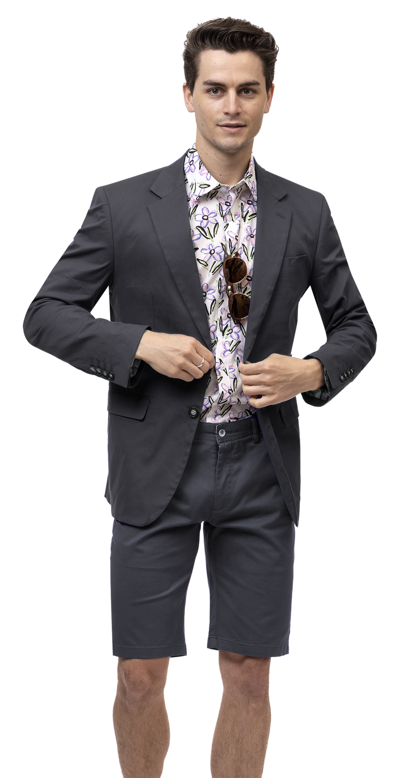 A man in an EJ Samuel floral shirt and chinos stands adjusting his EJ Samuel Charcoal Solid Chino Blazer CHJ01.