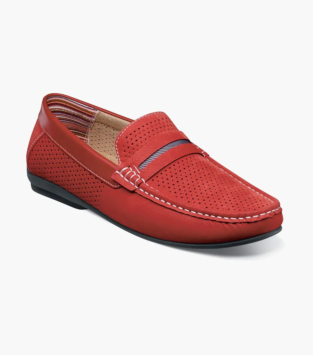 Introducing the Stacy Adams - CORBY Moc Toe Saddle Slip On in Red (25513-600). This shoe features a red leather loafer design with a perforated upper, complemented by black and red stripe detailing on top. It also boasts a durable rubber outsole, making it the ideal casual warm-weather shoe with its stylish appearance and comfortable fit from STACY ADAMS.