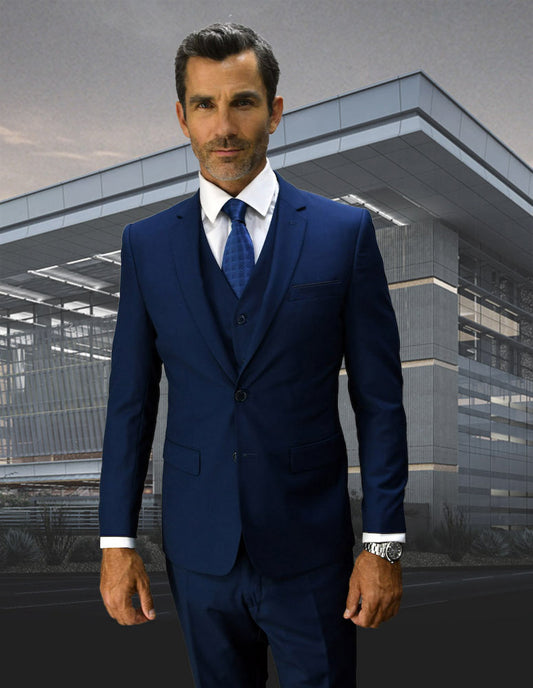 A man in a STATEMENT CLOTHING | CORTA-SAPPHIRE suit, designed by Statement Clothing with an ultra slim fit, stands confidently in front of a modern building.