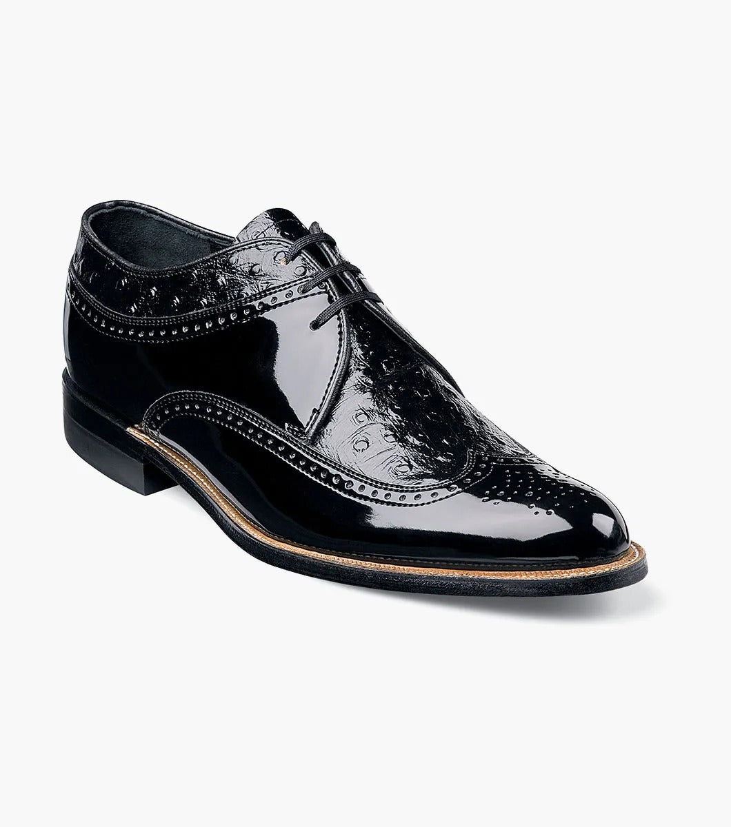 The Stacy Adams - DAYTON Ostrich Wingtip Oxford in black, style number 00375-01, is a single leather dress shoe with decorative perforations and a polished finish. It features laces and a slight heel.