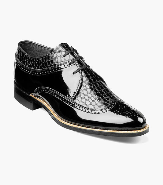 Introducing the Stacy Adams DAYTON Snakeskin Wingtip Oxford in Black, model 00605-01, a patent leather shoe designed with a shiny black finish and intricate patterns on the upper. This exquisite pair features laces and a low heel for added sophistication.