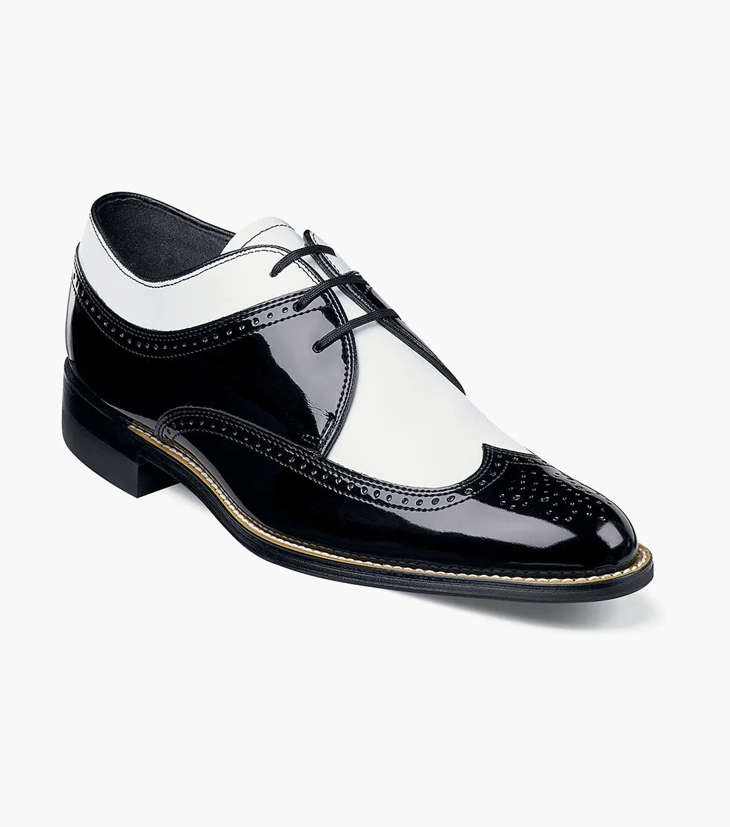 The Stacy Adams - DAYTON Snakeskin Wingtip Oxford in black and white is a sophisticated shoe from STACY ADAMS, expertly crafted from premium patent leather. It features a lace-up closure and classic Goodyear welt construction, set against a plain background.