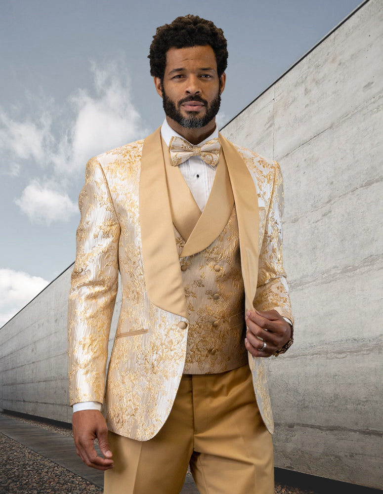 A man in the STATEMENT CLOTHING | DELANO-CHAMPAGNE tuxedo by Statement Clothing stands outside near a concrete wall, with a partly cloudy sky in the background.