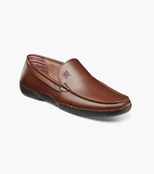 The Stacy Adams DEL Moc Toe Loafer in brown (25533-200) showcases a refined leather design, complete with a stitched sole and striped inner lining. It features a cushioned insole for enhanced comfort. This slip-on loafer, displayed on a white background, seamlessly blends style with convenience.