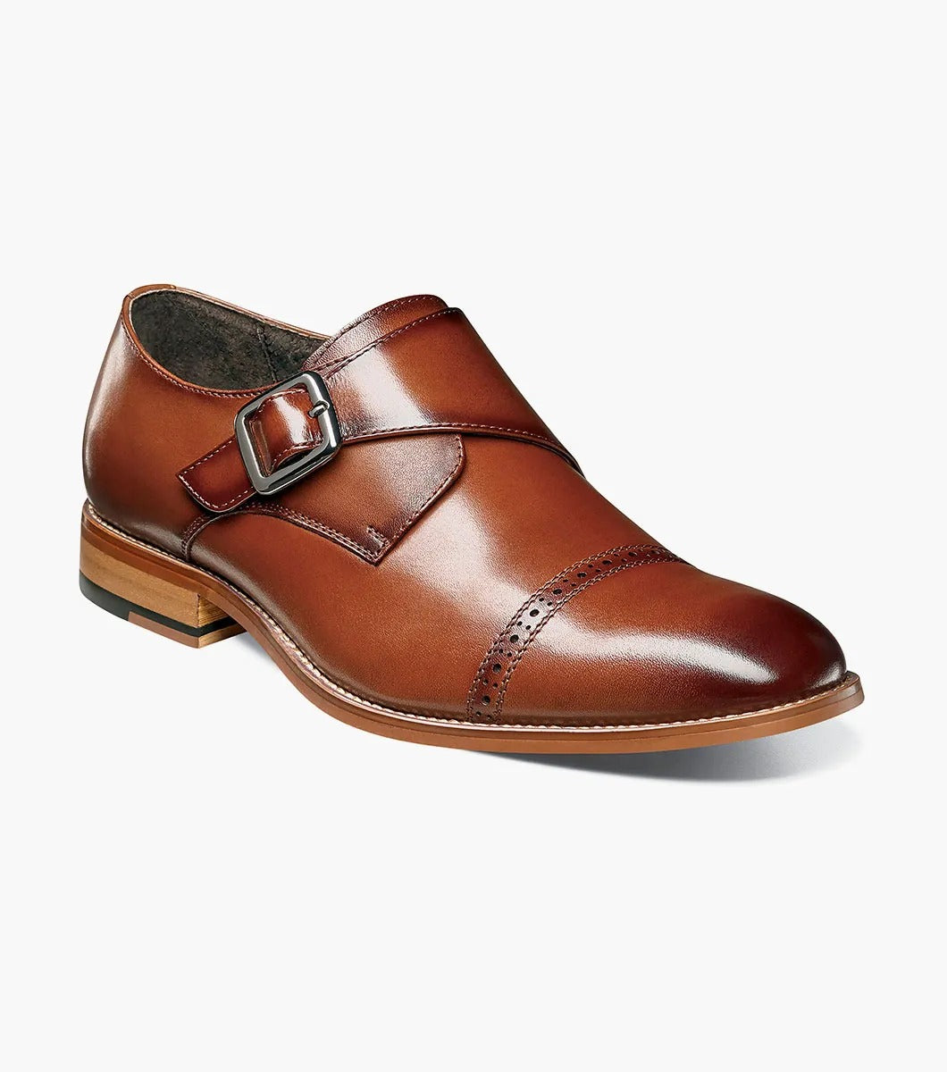 The Stacy Adams DESMOND Cap Toe Monk Strap in cognac combines a buckle, decorative perforations, cap toe detailing, and a wooden heel for a sophisticated look.