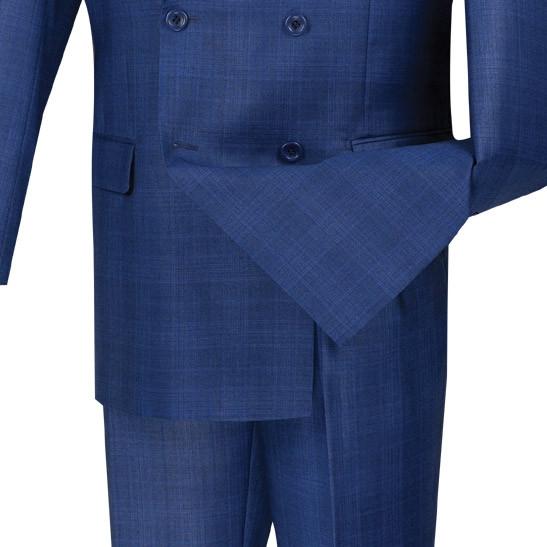 The Vinci Regular Fit Double Breasted Glen Plaid 2 Piece Suit in blue, featuring a wrinkle-resistant design, is displayed on a mannequin with a light shirt and a blue patterned tie.