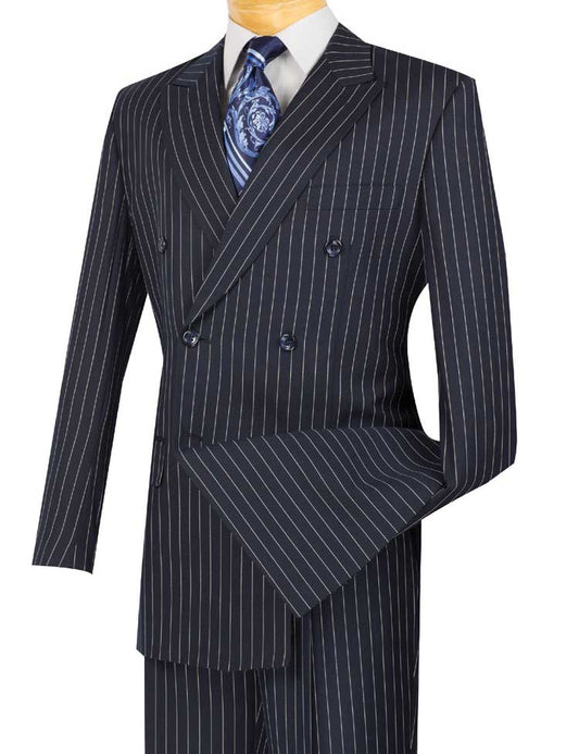 Displayed is the Vinci Suits' navy pinstripe double-breasted suit, comprising the Vinci Regular Fit Double Breasted Stripe 2 Piece Suit (Navy) DSS-4, along with pleated pants, a white dress shirt, and a patterned blue tie.