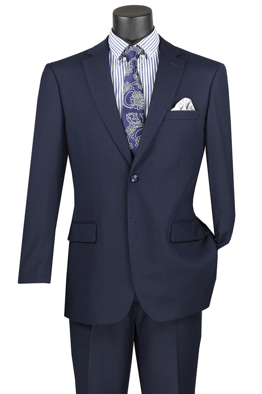 The mannequin is dressed in the Vinci Executive 2 Piece Suit with a Navy color, designed by Vinci Suits. The suit includes a jacket adorned with a notch lapel and a pocket square, paired stylishly with a striped shirt and paisley tie. Made to feel like wool, this ensemble blends elegance and comfort effortlessly.