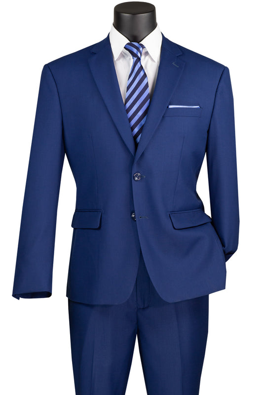 The Vinci Executive 2 Piece Suit with a 2″ Adjustable Waist Band in Twilight Blue from Vinci Suits offers a luxurious feel, complemented by a white dress shirt and a blue striped tie.