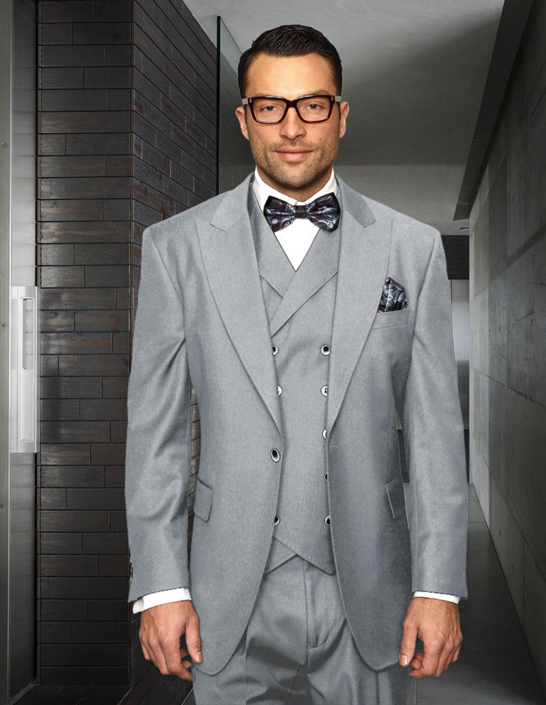 A man in a Florence-Gray three-piece suit by Statement Clothing and a bow tie stands in a hallway, facing forward. He is wearing glasses.