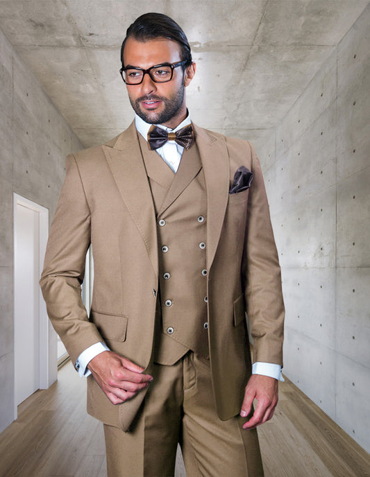 A man in the STATEMENT CLOTHING | FLORENCE-TAN Italian wool three-piece suit and glasses stands in a modern hallway with concrete walls.