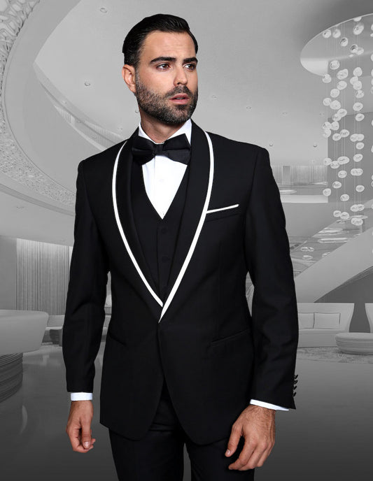 A man in a tailored fit STATEMENT CLOTHING | GENOVA-BLACK tuxedo with white trim and a bow tie stands against a modern backdrop inspired by Genova, reflecting the elegance of Statement Clothing.