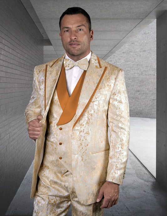 A gentleman wearing the GIANNI-BRICK ensemble from Statement Clothing, featuring pleated pants and a bow tie, stands in a corridor with gray brick walls.