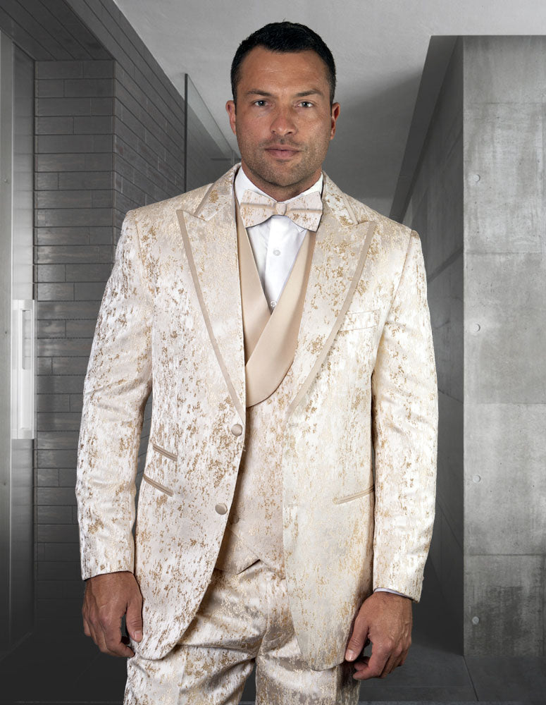 A man wearing the Gianni-Offwhite suit from Statement Clothing, featuring a regular fit with a matching bow tie and vest, stands in a modern hallway.