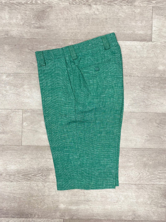 Inserch Premium Linen Flat Front Shorts in a green textured design, identifiable by their buttoned pocket, laid flat on a wooden floor—an essential addition to your summer wardrobe.