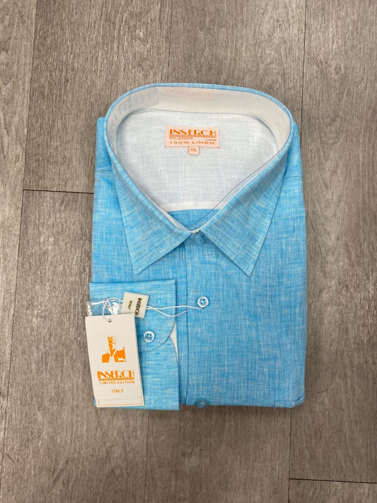 The Inserch Premium Linen Yarn-Dye Solid Long Sleeve Shirt 24116-92 in Ice Blue, complete with tags, is displayed on a wooden surface. This shirt features elegant contrast trimming that enhances its stylish appeal.