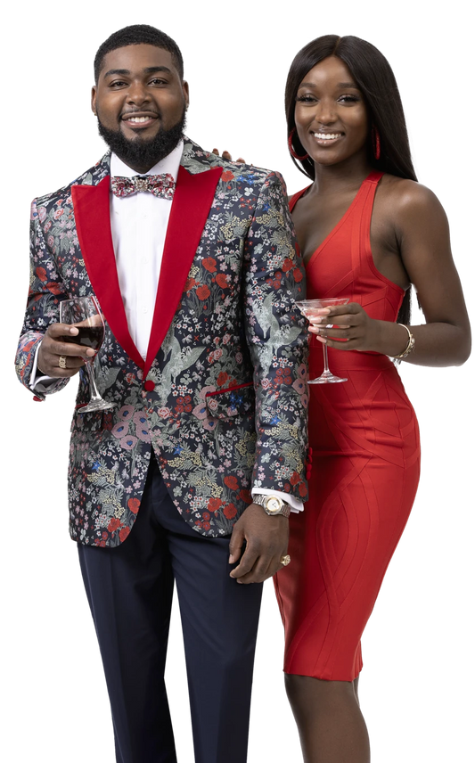 A man wearing an EJ Samuel Blue/Red Blazer J118 and a woman adorned with a red velvet lapel smile at the camera, wine glasses in hand, capturing the elegance of the moment.