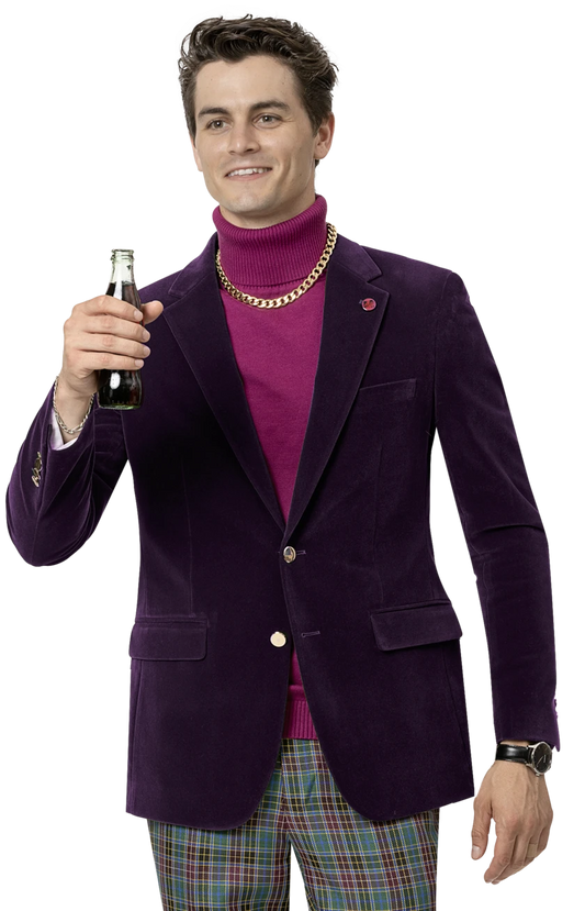 A person in an EJ Samuel Plum Velvet Blazer J134, featuring gold buttons, paired with a pink turtleneck, holds up a dark beverage bottle while wearing plaid pants and a gold chain necklace.