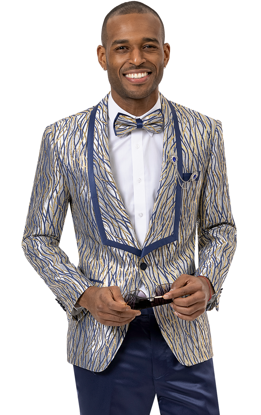 A person smiling, wearing the EJ Samuel Blue Blazer J146 adorned with a gold and blue pattern along with a matching bowtie, holding sunglasses in their hands.