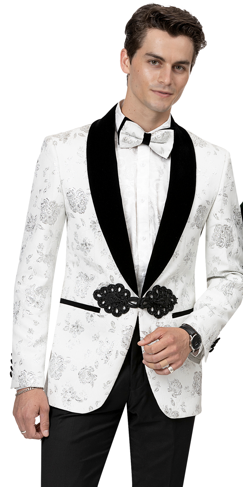 A man wearing the EJ Samuel White Blazer J168 by EJ SAMUEL, featuring a floral pattern and a fashion-forward black lapel with a matching white bow tie, sports an elegant blazer complete with a decorative belt.