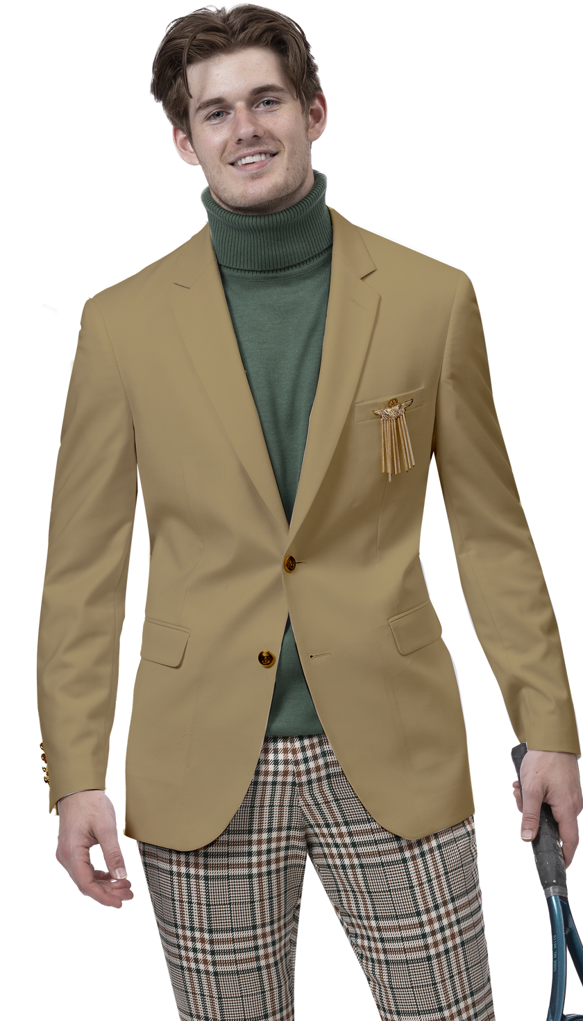 A person wearing the EJ SAMUEL Tan Blazer J170, featuring gold buttons, paired with a green turtleneck and plaid trousers, stands with a relaxed expression, holding a blue object in one hand.