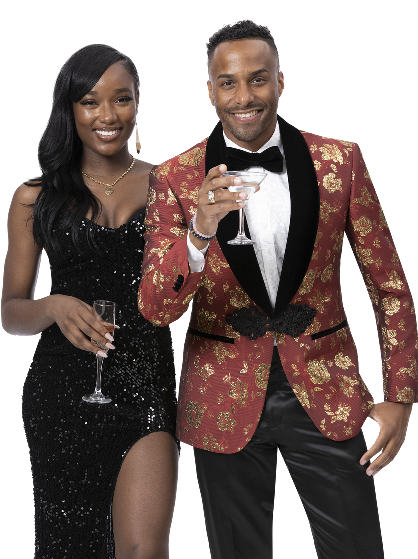 A woman in a black dress and a man wearing the EJ Samuel Blk/Red Blazer J176 with a bow tie hold glasses, smiling at the camera.