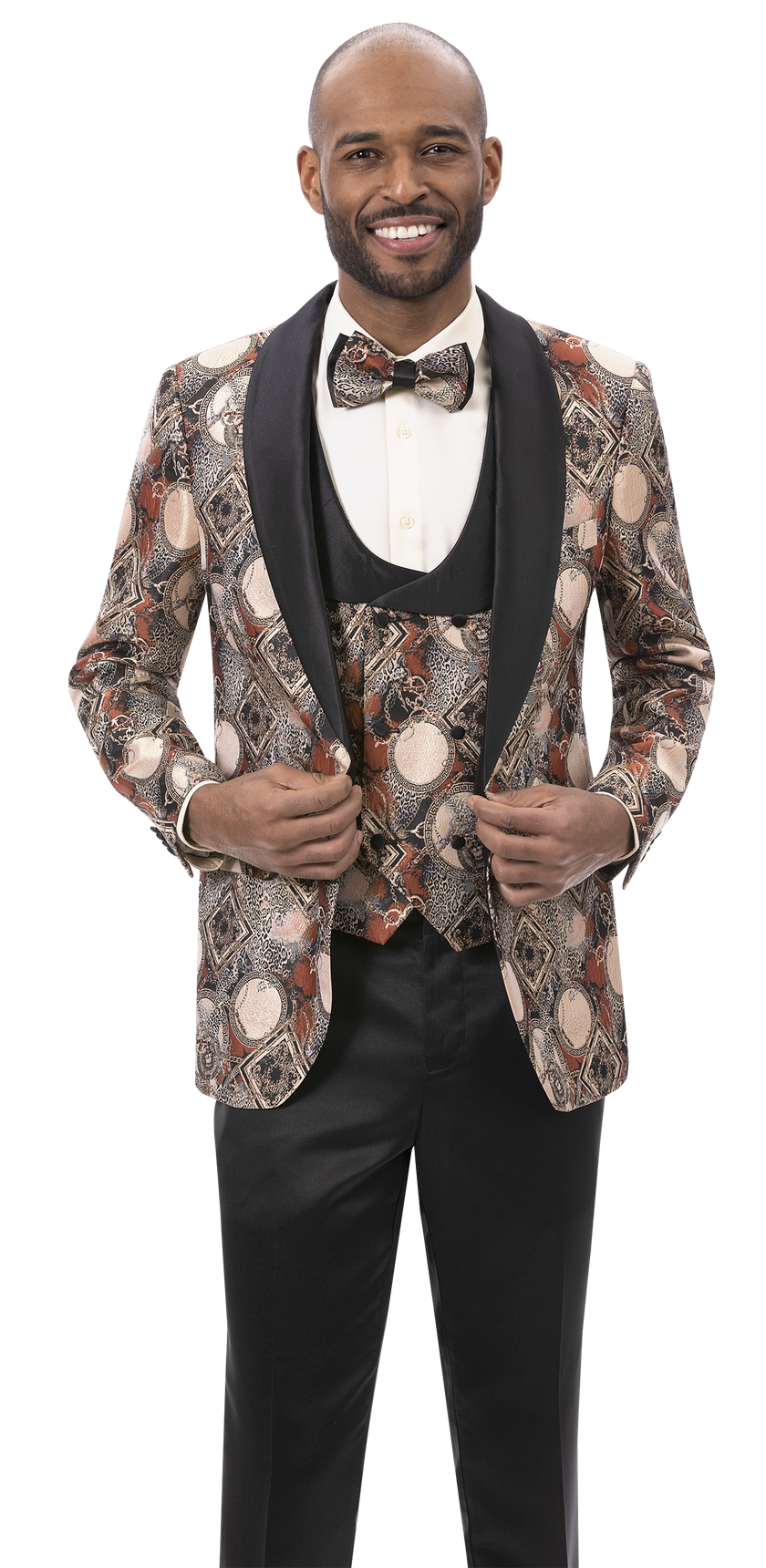 A man wearing the EJ Samuel Rust Blazer J180, complemented by a waistcoat and bow tie, stands smiling as he holds his jacket lapels.