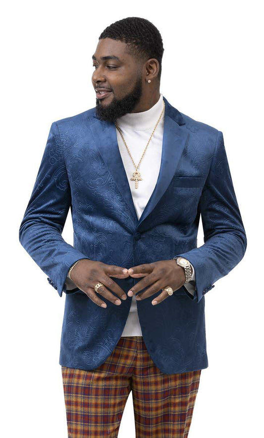 A man in an EJ Samuel Aqua Blazer J37 (final sale, size 40R only) with a modern fit velvet paisley design pairs it with plaid pants as he looks to the side. He completes the look with a white turtleneck, gold chain, and rings.