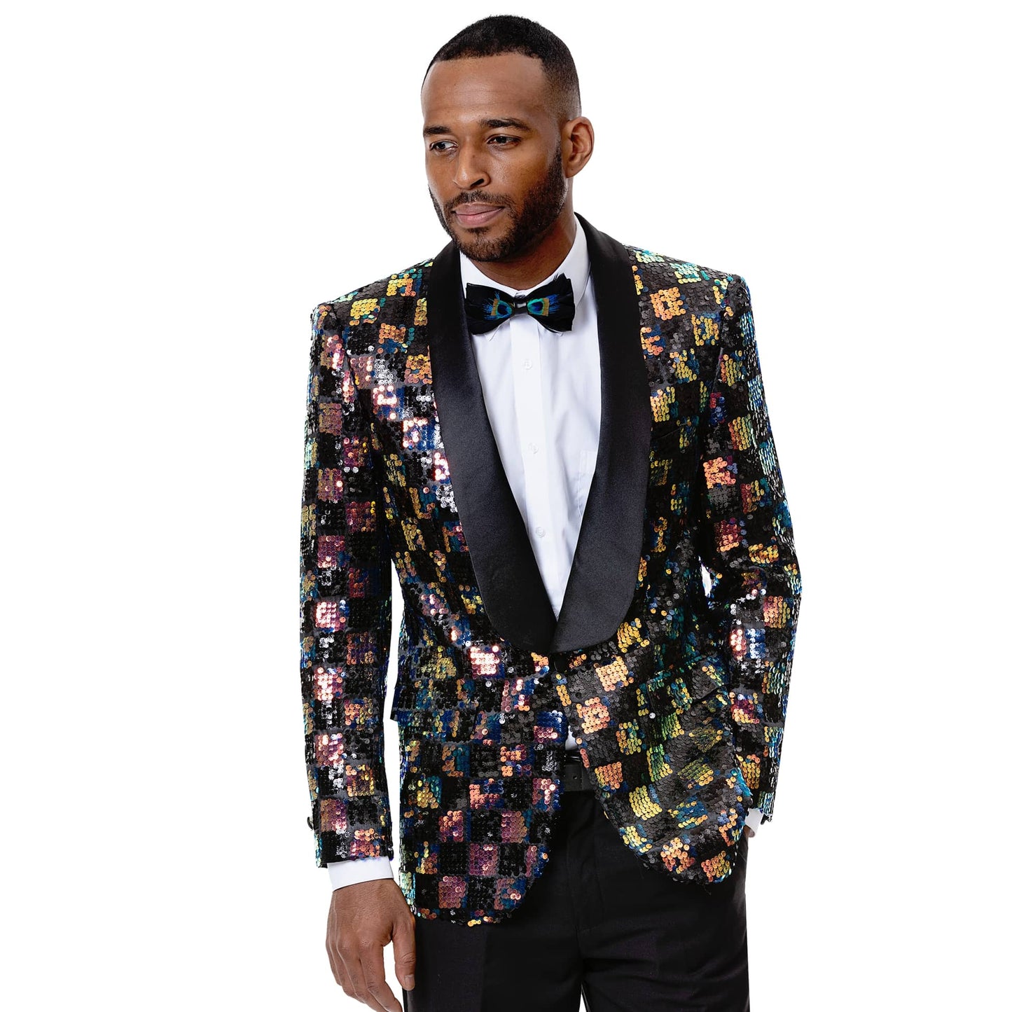 A man standing against a white background, is dressed in an EJ Samuel Multi Blazer J55 featuring sequins and a multi-colored design, complemented by a sleek satin lapel, paired with a white shirt, black bow tie, and modern fit black pants.