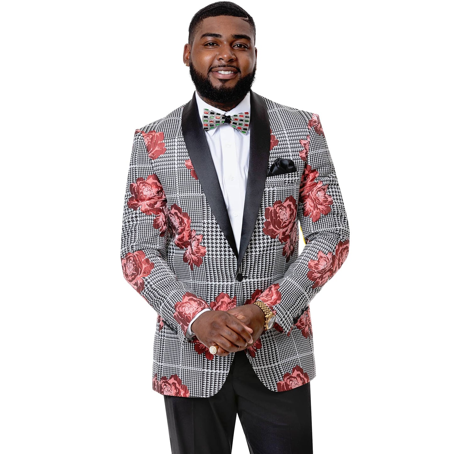 A man wearing the EJ Samuel Houndstooth Blazer J60, featuring a modern fit with red floral accents and a bow tie, alongside a satin shawl lapel, is standing against a white background.