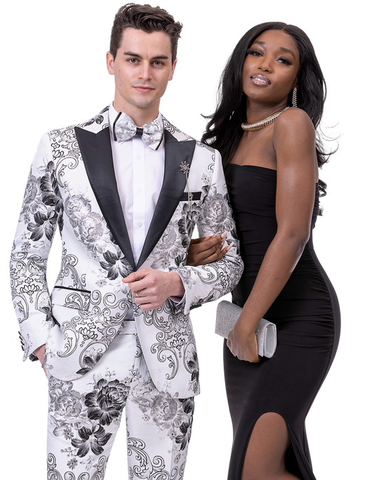 A man wearing the EJ Samuel Wht/Blk Suit JP103 accompanied by a matching bowtie and a woman in a black dress pose together.