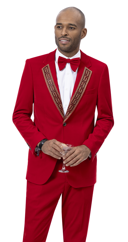 A man in the EJ Samuel Red Suit JP110 by EJ SAMUEL, featuring decorative trim, paired with a white shirt and red bow tie, holds an empty wine glass.