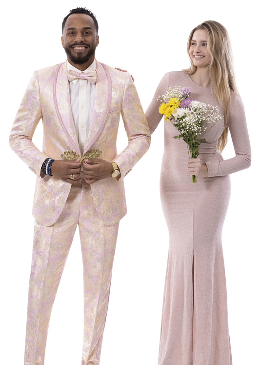 A man wearing the EJ Samuel Pink Suit JP111 by EJ SAMUEL, complete with a matching bowtie and boutonniere, stands beside a woman in a pink gown holding a bouquet and smiling.