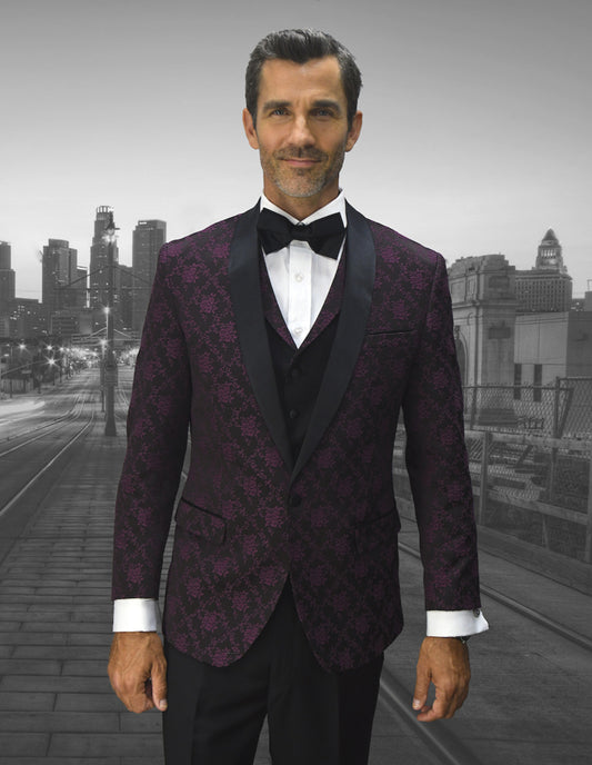 A man wearing Statement Clothing's LOOK-8-BURGUNDY suit, featuring a modern fit and bow tie, stands in front of a blurred cityscape.