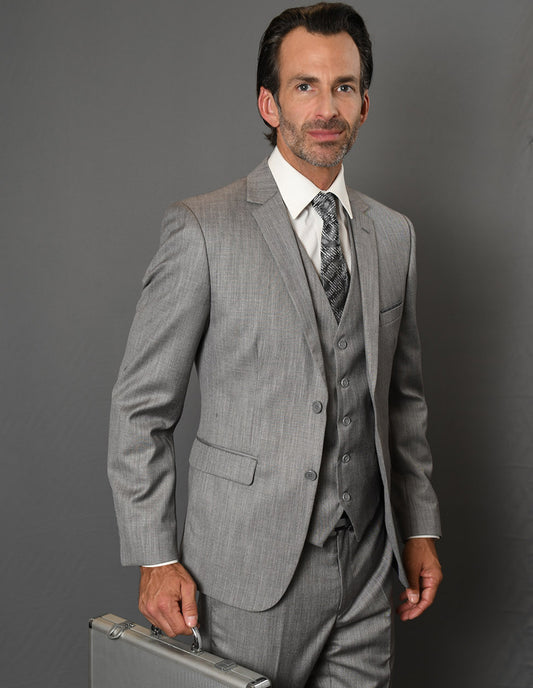 A man in a Lorenzo-1-Grey slim fit suit from Statement Clothing, tailored to perfection, holds a briefcase against a grey background.