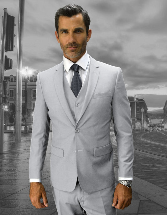 Dressed in a sleek Lorenzo-Ash slim fit suit from Statement Clothing, the man stands confidently against an urban backdrop, showcasing flat front pants that perfectly capture modern elegance and sophistication.